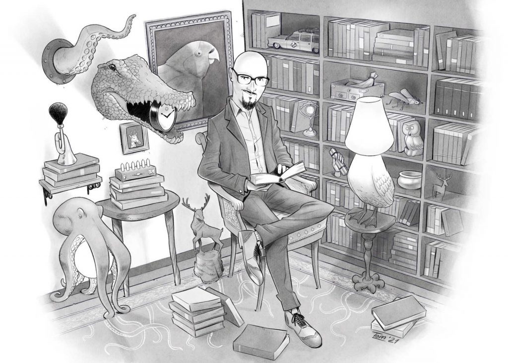 Ritratto in bianco e nero dell'autore seduto, calvo con occhiali e pizzetto in una biblioteca con disegni di animali